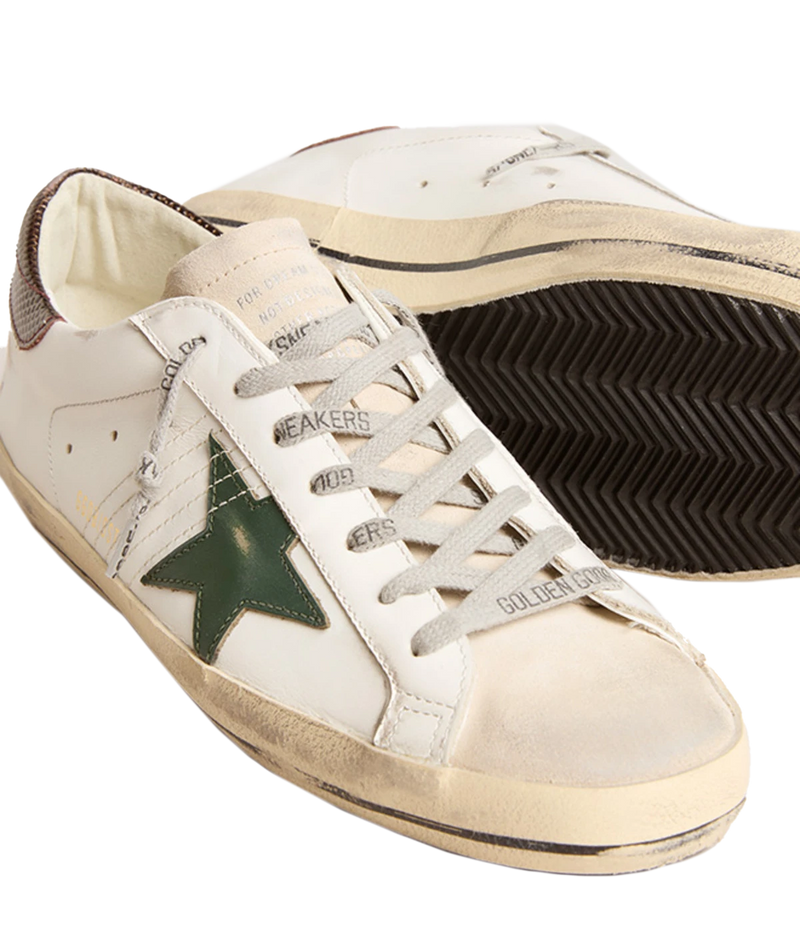 A pair of Golden Goose Super Star Sneakers in white, seed pearl, green, and brown, featuring the brand's signature distressed finish for a relaxed, worn-in look. The sneakers include a signature star patch on the sides and a contrasting green and brown heel counter. Designed with a front lace-up fastening, round toe, and flat rubber sole, these sneakers are perfect for everyday wear, offering a mix of style, comfort, and signature Golden Goose flair.