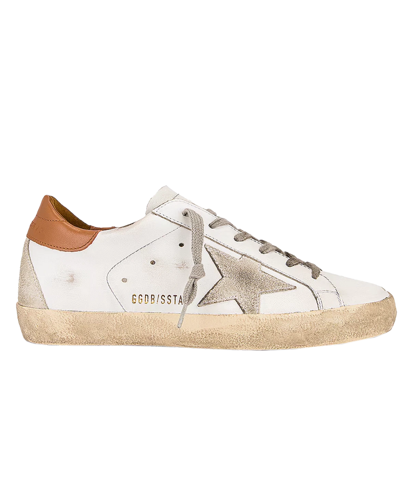 The Golden Goose Super-Star Sneakers in White, Ice & Light Brown feature leather uppers with a distressed finish for a vintage-inspired look. A brown accent at the heel adds a stylish touch, while the iconic star motif on the side wall stands out. With a rubber sole and round toe, these sneakers combine effortless style and comfort, making them a versatile addition to any casual wardrobe.