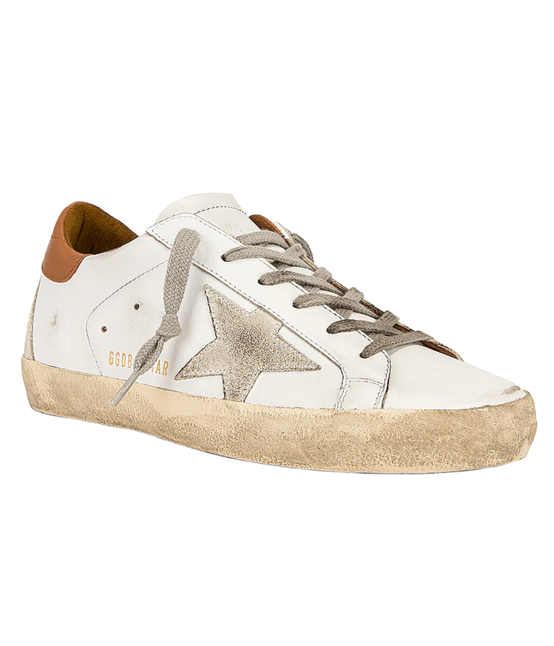 The Golden Goose Super-Star Sneakers in White, Ice & Light Brown feature leather uppers with a distressed finish for a vintage-inspired look. A brown accent at the heel adds a stylish touch, while the iconic star motif on the side wall stands out. With a rubber sole and round toe, these sneakers combine effortless style and comfort, making them a versatile addition to any casual wardrobe.