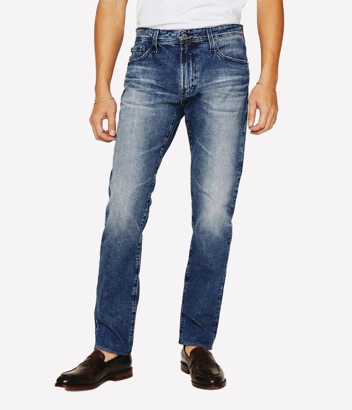Tellis Modern Slim Jean for men in dark indigo with heavy fading and distressing for an AG-ed™ look. Crafted from 11 oz. Lead Denim with comfort stretch, featuring a fitted upper block and tapered leg opening