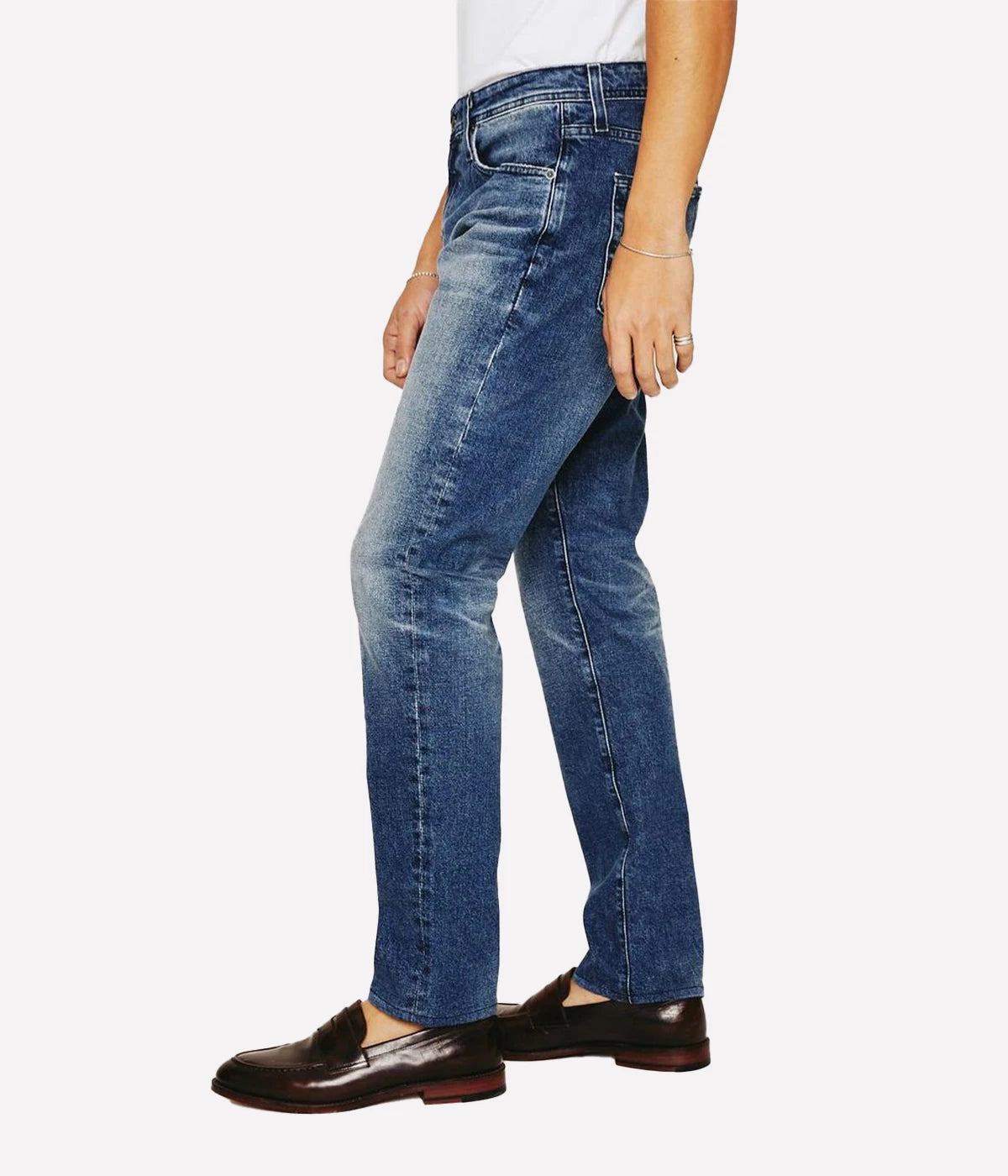Tellis Modern Slim Jean for men in dark indigo with heavy fading and distressing for an AG-ed™ look. Crafted from 11 oz. Lead Denim with comfort stretch, featuring a fitted upper block and tapered leg opening