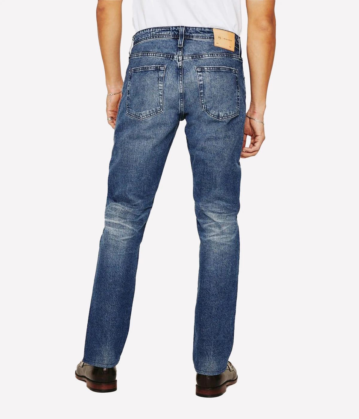 Tellis Modern Slim Jean for men in a dark indigo wash with heavy fading and distressing for an authentic AG-ed™ vintage look. Designed with a fitted upper block and tapered leg opening, these five-pocket jeans are crafted from 11 oz. Lead Denim with comfort stretch for all-day ease and style.