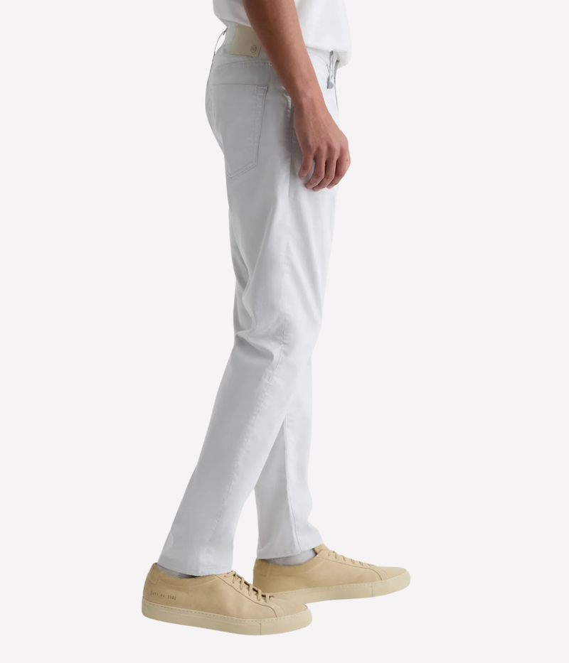 AG Tellis slim fit jeans in 'Almost White' Airluxe™ sateen—lightweight, breathable, and tailored with a tapered leg for modern comfort.