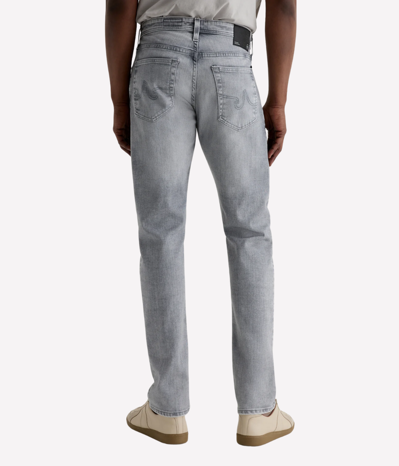 AG Tellis slim fit jeans in black Vapor Wash, made from stretch Italian denim with a tapered leg and sustainable finish.