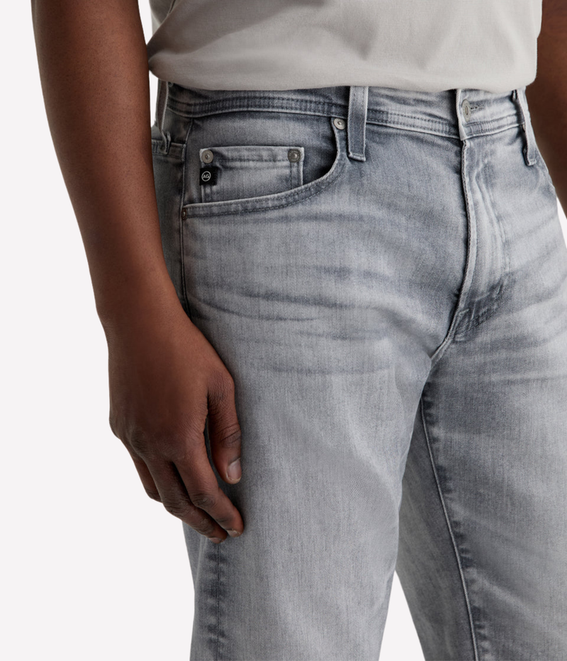 AG Tellis slim fit jeans in black Vapor Wash, made from stretch Italian denim with a tapered leg and sustainable finish.