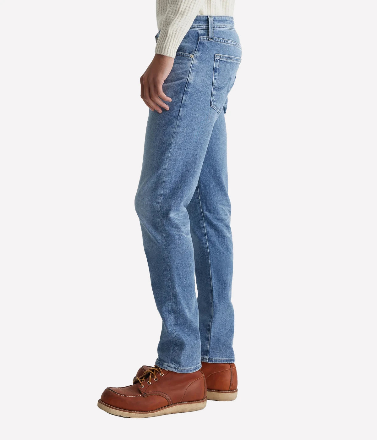 AG Tellis slim-fit jeans for men in a 16-year AG-ed™ light blue, featuring tapered leg opening and fitted upper block. Crafted from 9.4 oz. Hyper Soft Indigo Denim with AG's Cloud Soft Denim™ and dual-elastic performance fibres for a soft, stretchy feel