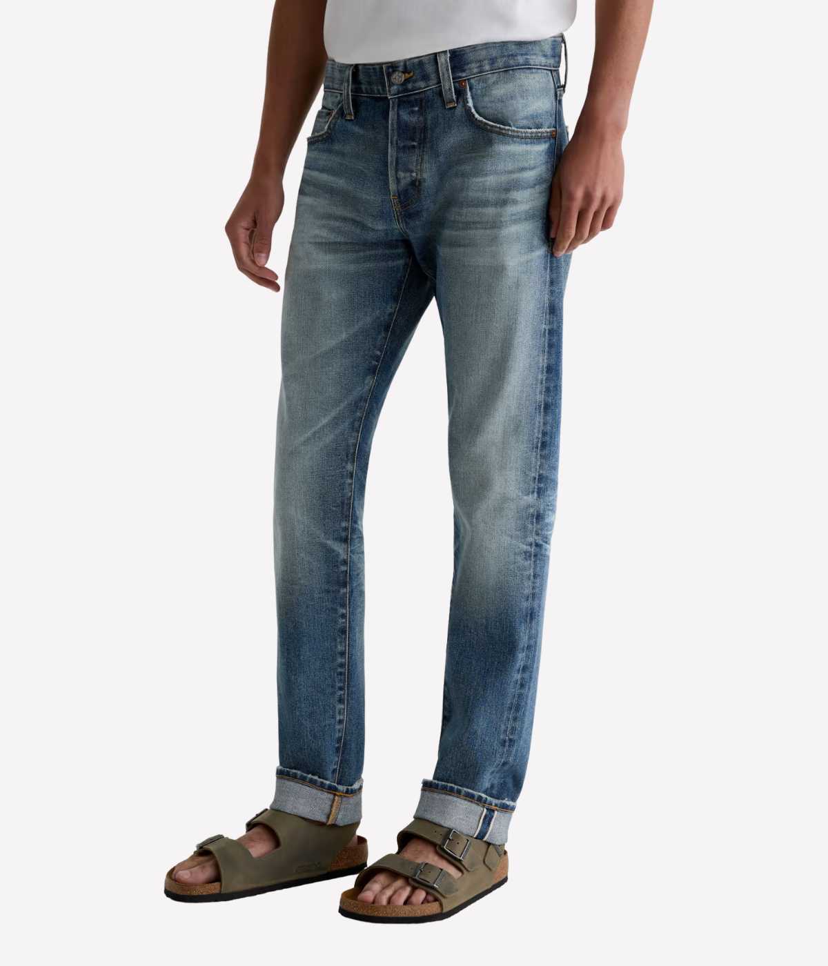 Men’s AG Tellis jeans in 14-year faded blue AG-ed™ wash, crafted from Japanese stretch selvage denim with a modern slim fit and tapered leg.