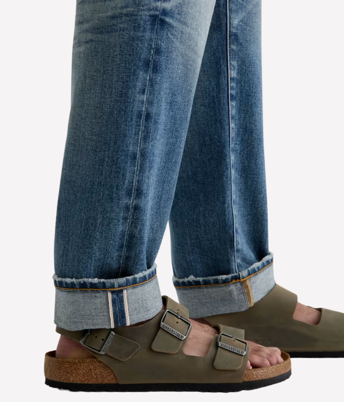 Men’s AG Tellis jeans in 14-year faded blue AG-ed™ wash, crafted from Japanese stretch selvage denim with a modern slim fit and tapered leg.
