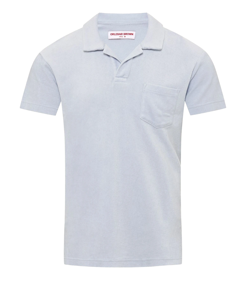 A short sleeve casual polo in a light baby blue colourway, featuring a terry towling fabric, collar detail and singular chest pocket. Beach to Bar, everyday polo, comfortable, holiday outfit.  