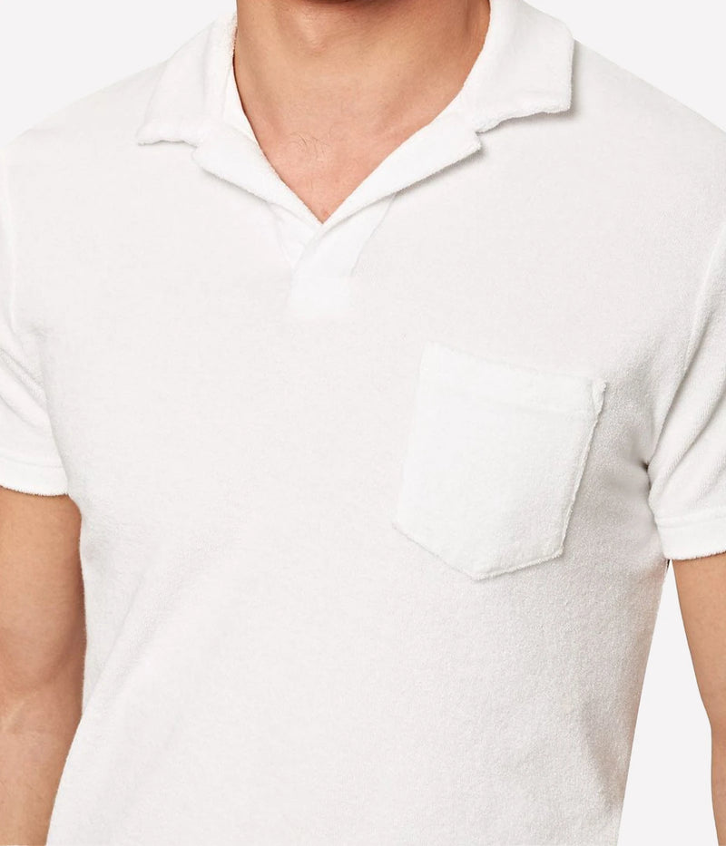 White terry towelling polo by Orlebar Brown, featuring a soft and breezy fabric with a stylish open placket. The tailored fit ensures comfort without being too snug, making it the perfect casual yet polished piece. Pair it with Orlebar Brown swim shorts for a complete holiday look. Made from 100% terry towelling cotton.
