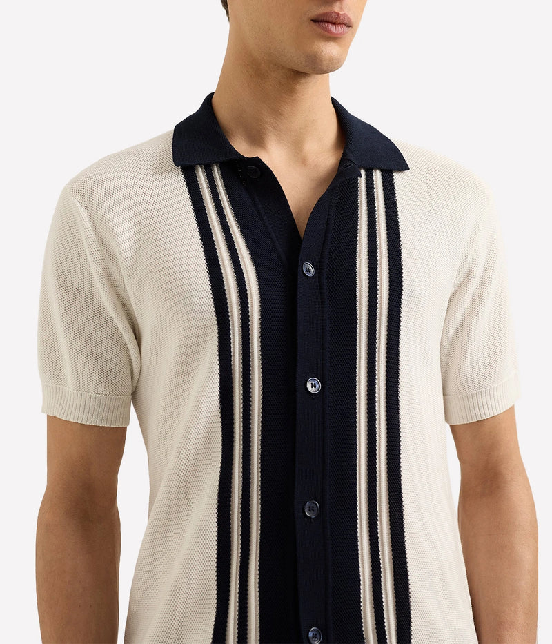 Men’s Tiernan classic fit shirt made from organic mercerised cotton piqué with Milano collar and contrast stripe stitch detail, displayed under soft candlelight.