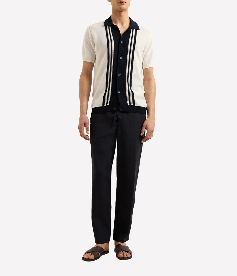 Men’s Tiernan classic fit shirt made from organic mercerised cotton piqué with Milano collar and contrast stripe stitch detail, displayed under soft candlelight.