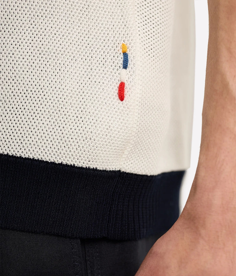 Men’s Tiernan classic fit shirt made from organic mercerised cotton piqué with Milano collar and contrast stripe stitch detail, displayed under soft candlelight.