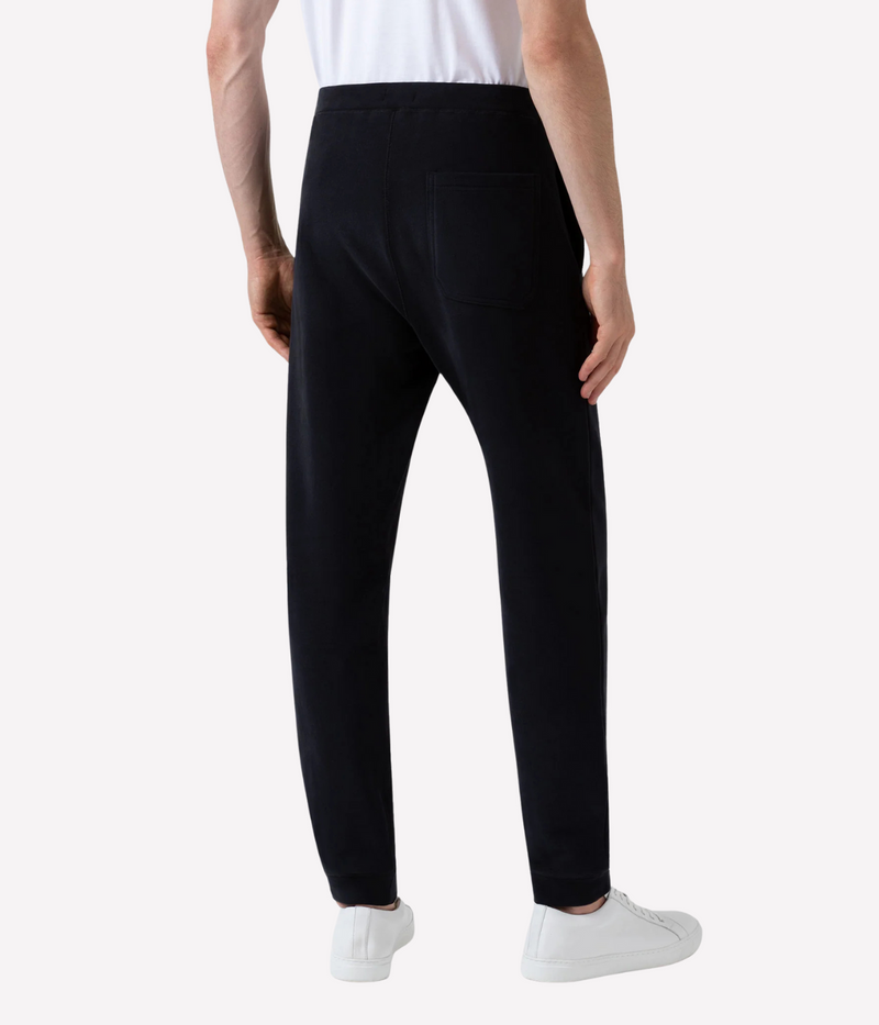 Men’s slim fit track pants in black, crafted from loopback cotton with ribbed waistband and tapered leg—part of a matching track set.