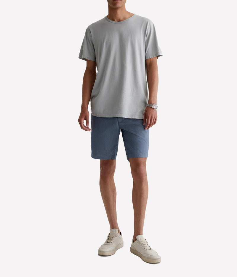 AG Wanderer Shorts styled with a short-sleeve shirt and sneakers, showcasing a relaxed yet polished outfit for versatile, warm-weather wear.