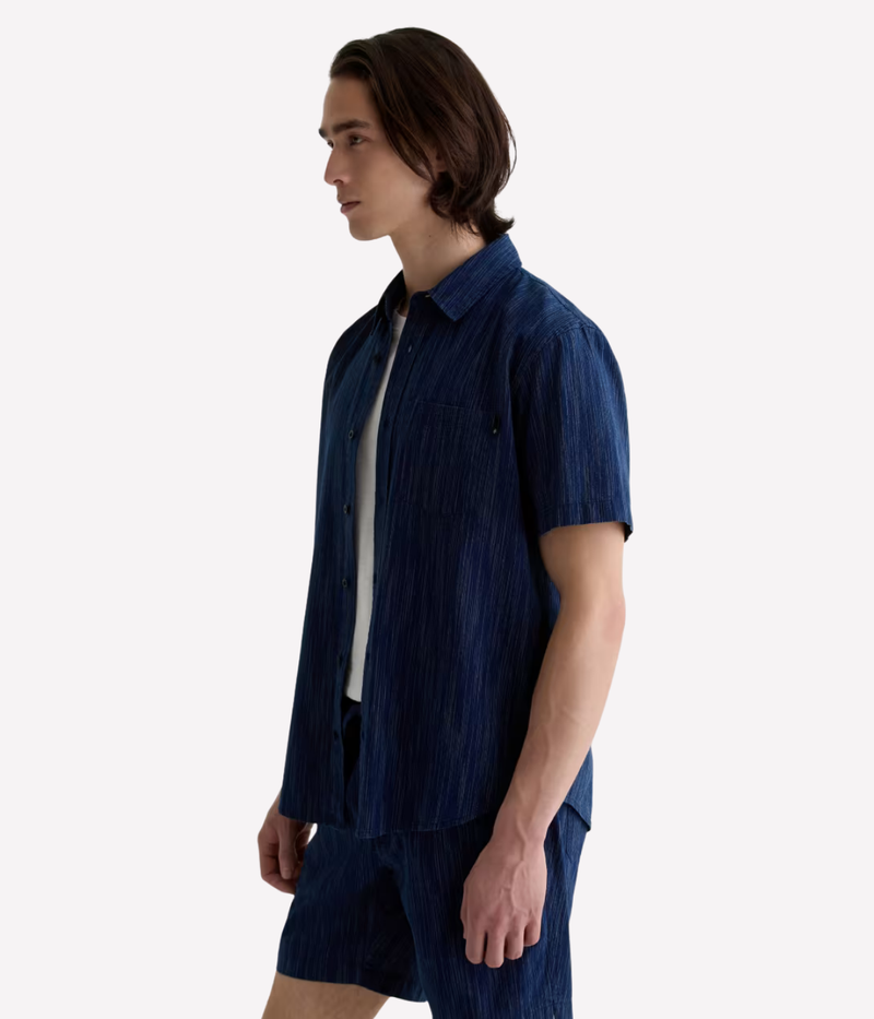 Relaxed short sleeve chambray shirt in a textured blue wash with chest pocket – the perfect laid-back summer button-up.