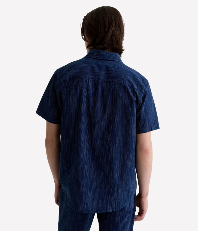 Relaxed short sleeve chambray shirt in a textured blue wash with chest pocket – the perfect laid-back summer button-up.