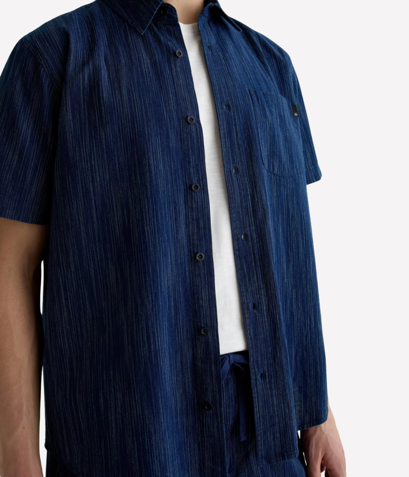 Relaxed short sleeve chambray shirt in a textured blue wash with chest pocket – the perfect laid-back summer button-up.