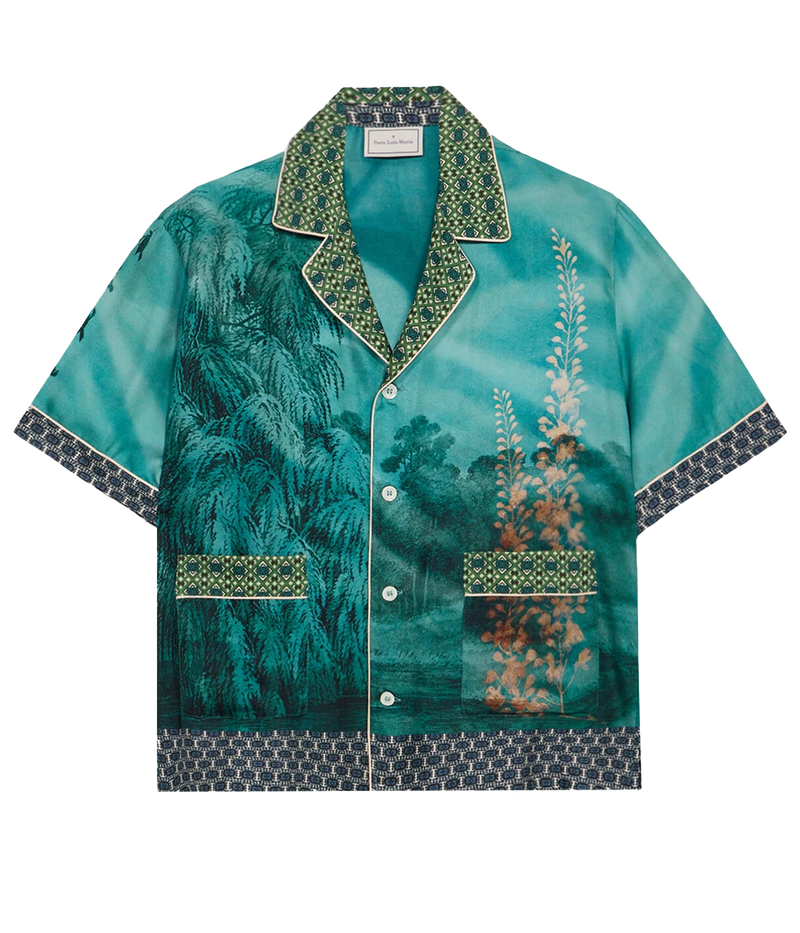 Short-sleeved silk shirt with teal landscape, botanical, and bird motifs, open collar, and button front.