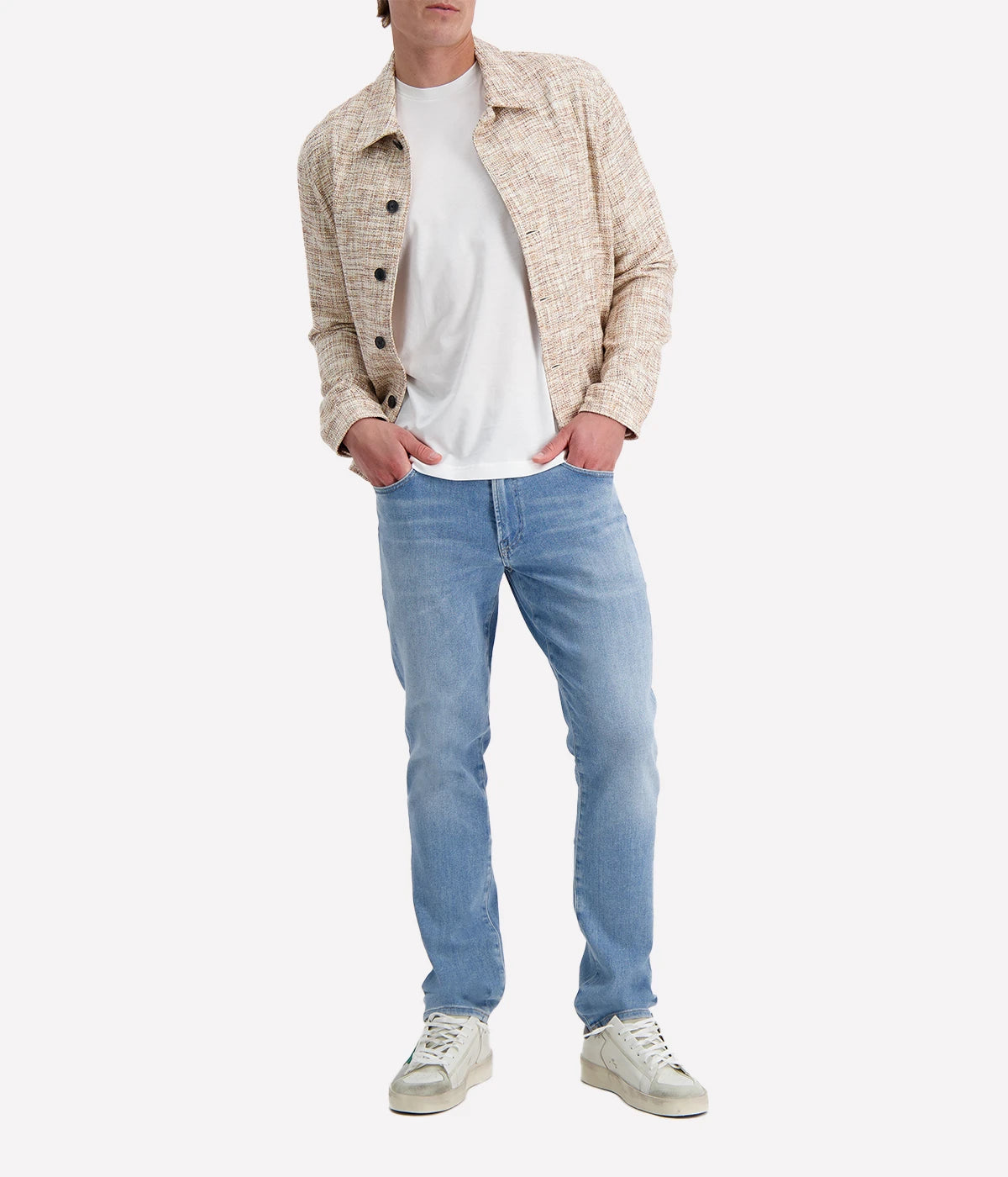 John Varvatos cream and brown textured trucker jacket with black buttons, worn over a white T-shirt and blue jeans for a modern casual look.