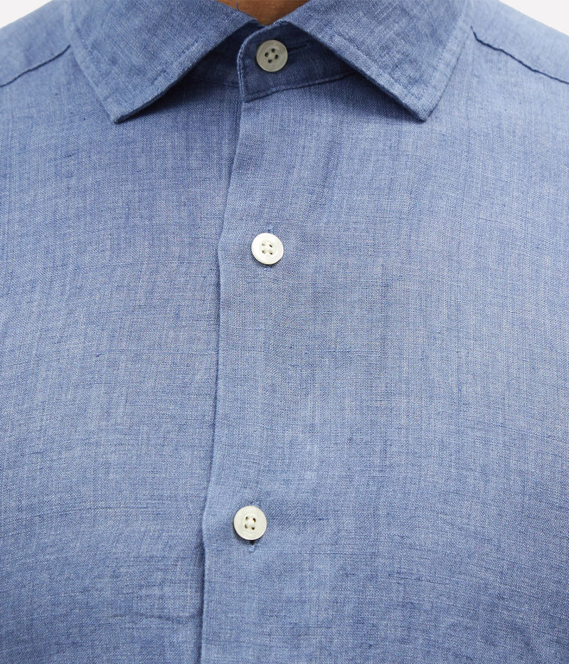 Close-up of the Antonio Long Sleeve Linen Shirt by Frescobol Carioca, crafted from premium fine Italian linen. The smooth texture and lightweight feel of the fabric ensure comfort and elegance, enhanced by imitation mother of pearl buttons for a sophisticated finish.