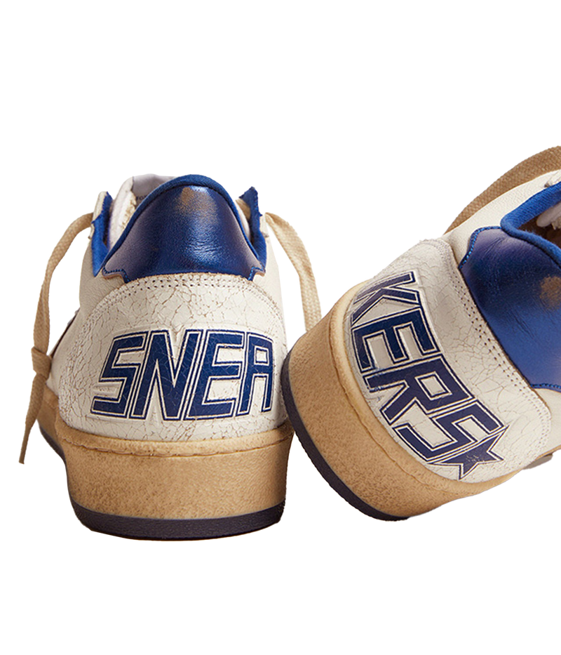 Golden Goose Ball Star sneakers channel an '80s American college and basketball vibe. Crafted in white nappa leather, they feature a metallic navy leather star and heel tab, along with white crackle-leather inserts. The sneakers are completed with white laces, giving them a vintage-inspired look with modern appeal.