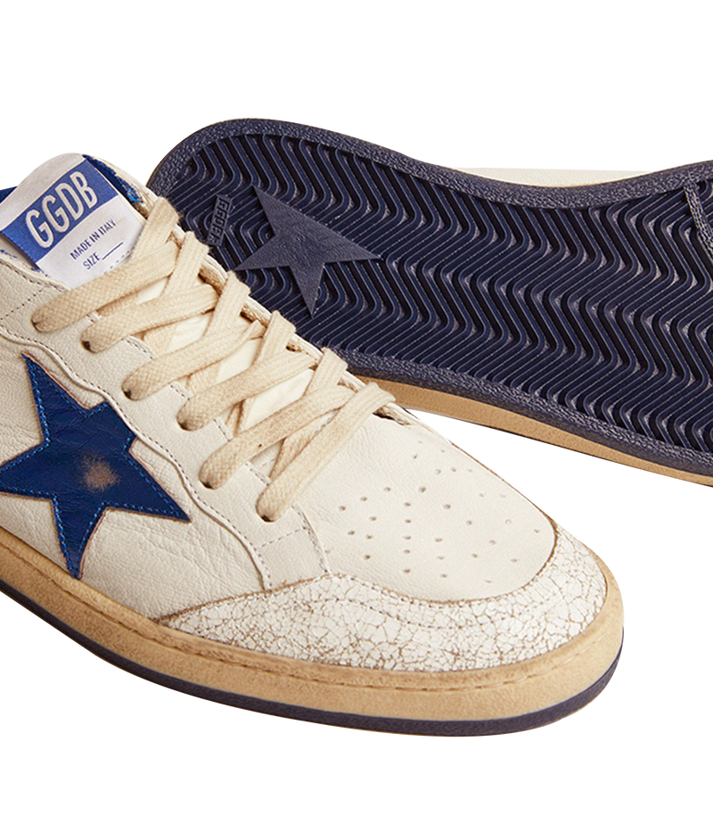Golden Goose Ball Star sneakers channel an '80s American college and basketball vibe. Crafted in white nappa leather, they feature a metallic navy leather star and heel tab, along with white crackle-leather inserts. The sneakers are completed with white laces, giving them a vintage-inspired look with modern appeal.