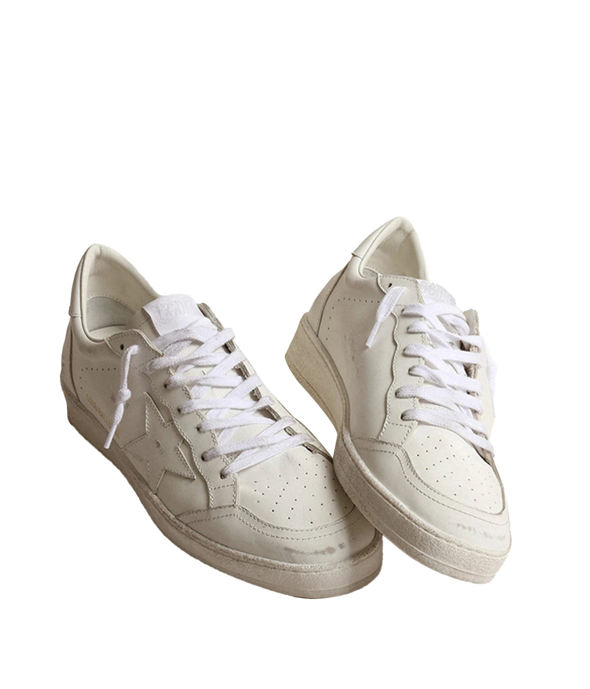 Golden Goose Ball Star sneakers in Optic White, featuring a leather upper and signature star. Inspired by an American college vibe, blending basketball and skate culture. The white leather inserts and tonal laces complete the timeless, stylish look.