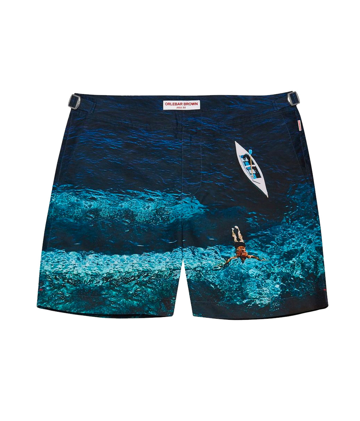 Orlebar Brown Deep Sea Print Swim Shorts featuring a moody, rippled water effect inspired by a 1958 Slim Aarons photograph. Dark blue hue and tailored fit with adjustable side fasteners.