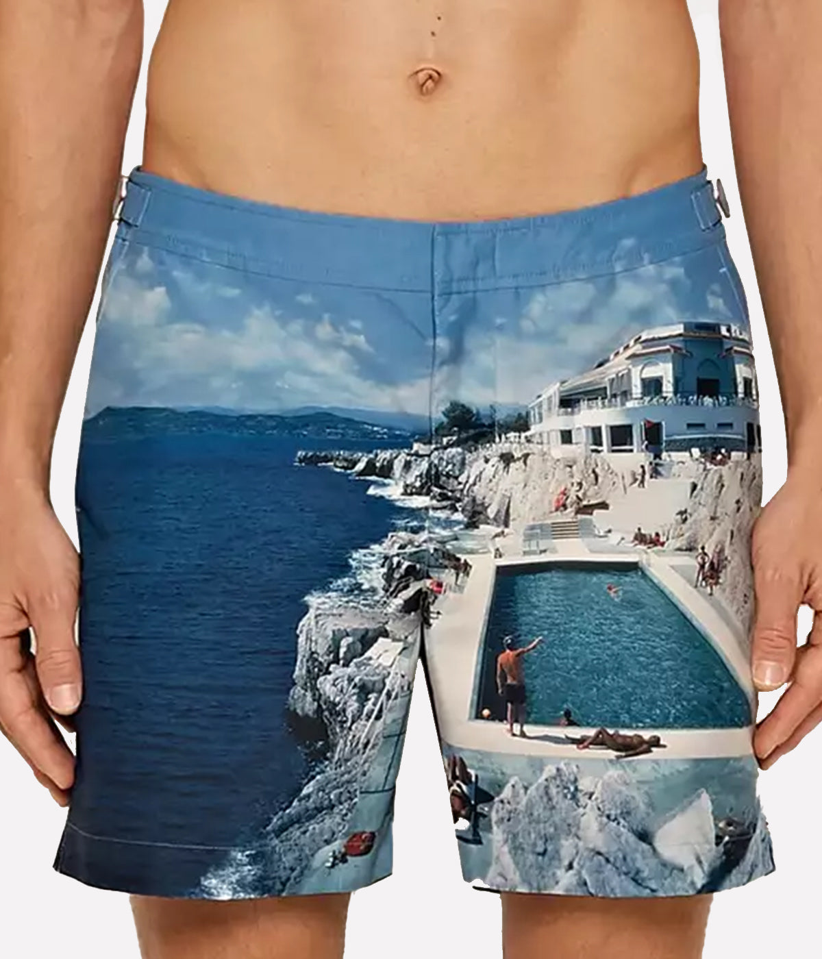 Orlebar Brown Bulldog Swim Shorts featuring a Slim Aarons medley of inviting blues from the iconic Roc Pool shot, offering effortless style and quick-dry fabric for ultimate summer versatility.