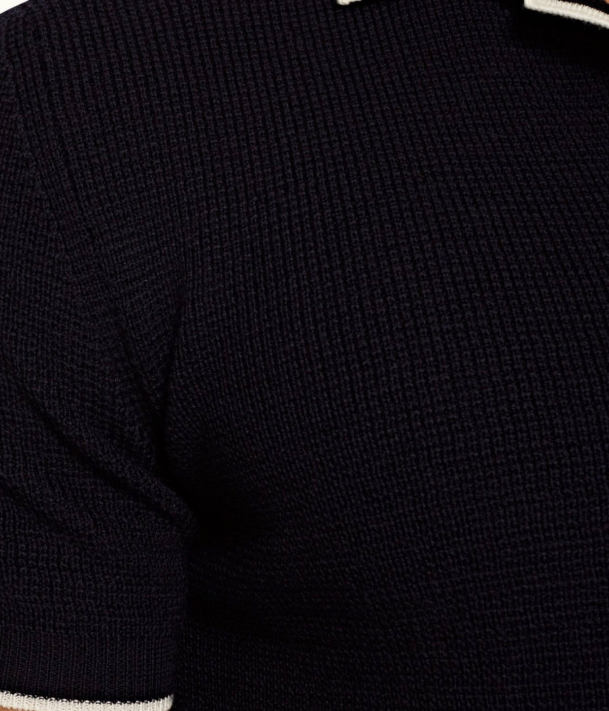Navy Horton polo shirt featuring a tailored fit and fine stripe detail on the collar, cuffs, and hem. Made from 100% Merino wool with a waffled knit for comfort and durability. Dry clean only