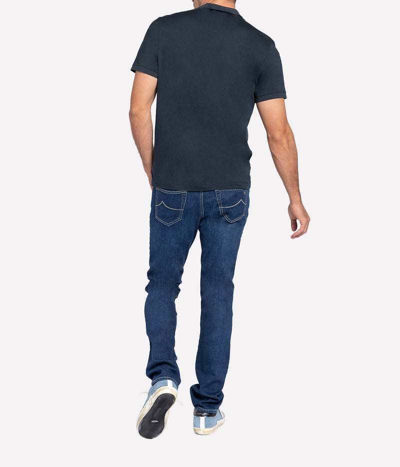 Back view of the James Perse Luxe Lotus Jersey Polo, showcasing the soft cotton fabric and clean finished straight hem. The collar and short sleeves maintain a polished, relaxed look for effortless styling.