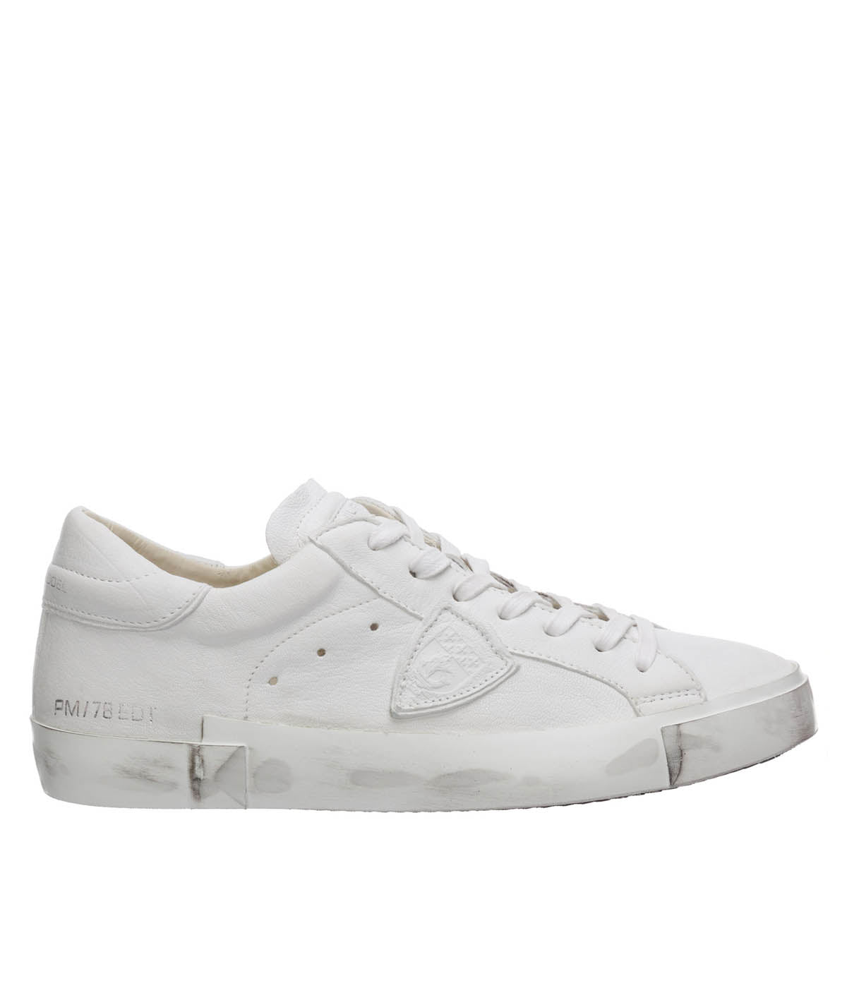 Side view of Philippe Model PRSX Low Man sneakers showcasing the unique vintage-effect design, with a patented foxing tape creating an imperfect sole. The shield on the side features the City of Paris coat of arms. The upper is crafted from high-quality Italian calfskin and suede, with laminated suede inserts.